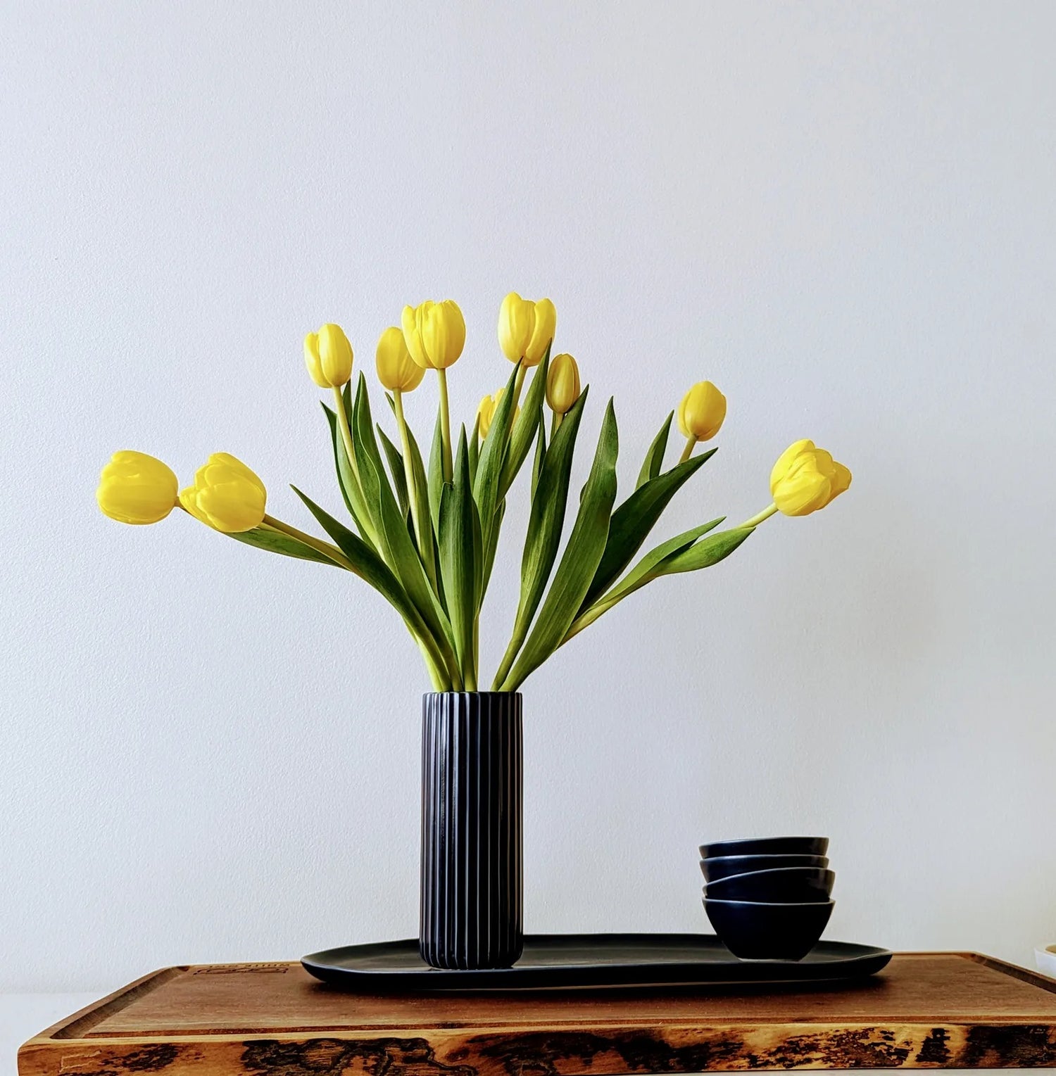 Ribbed ceramic vase showcasing vibrant florals, combining bold simplicity with natural elegance for home decor